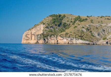 Natural scenery near Cala Ratjada at sea with boat wake in Mallorca, Balearic islands, Spain.