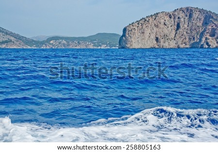 Boat wake in clear blue water by southern Majorca coast, Mallorca, Balearic islands, Spain.