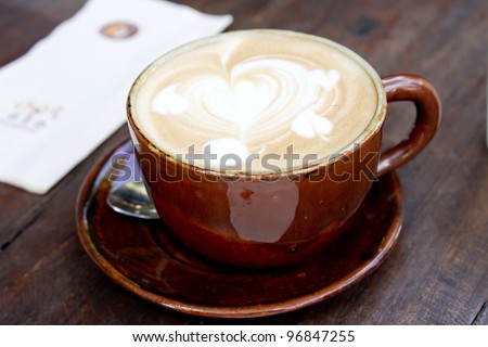 Heart drawing on cappuccino art coffee cup