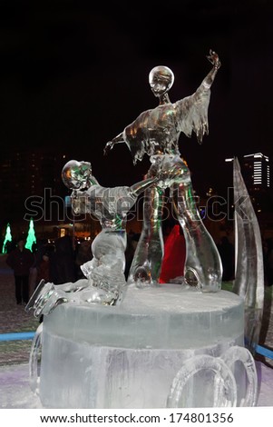 PERM, RUSSIA - JAN 11, 2014: Ice sculpture figure skating at night in Ice town, created in honor of Winter Olympic Games 2014 will be in Sochi, Russia.