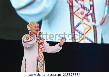 PERM, RUSSIA - JUNE 25, 2014: Singer of folk songs in national dress singing at festival White Nights