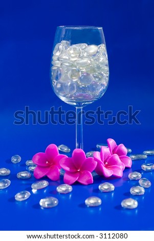 Wine glass with sparkling stones on a blue background