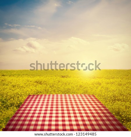 Picnic Template With Tablecloth In Buttercup Field Against Sun In Sky