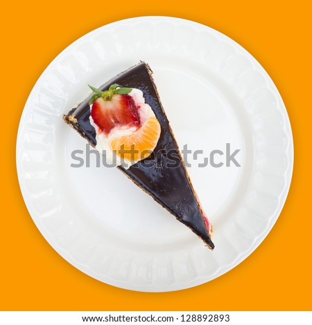 Fruit cake overhead view on orange background with clipping path