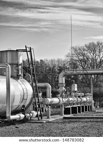 Black and white image of a gas facility in natural environment