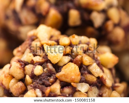 Macro image of a chocolate truffle with nut topping