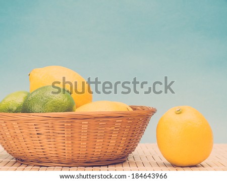 Citrus fruit in wicker basket, retro toned