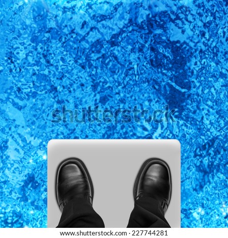 Business man feet on ledge of diving board, overhead view