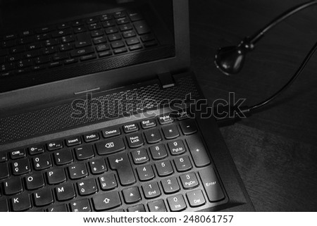 USB led light plugged into laptop, black and white image