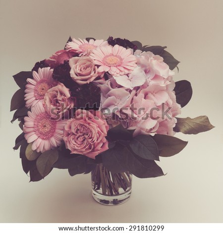 Bouquet pink flowers in vase, vintage toned