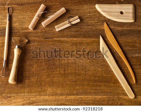 Sculpting tools on wooden table with copy space