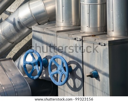 Blue valves from water pumping station with pipelines
