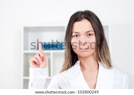 portrait of a beautiful woman, points her finger up
