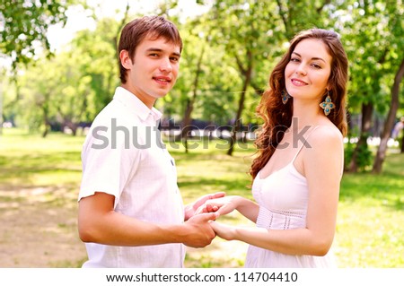 couple holding hands in the park, spending time with loved ones