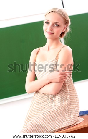 portrait of a beautiful female teacher, hugging her arms