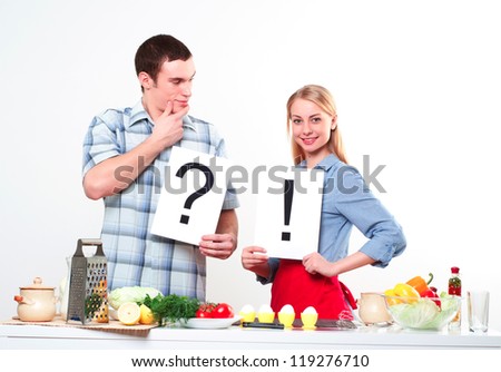 couple holding a plate with signs question and exclamation