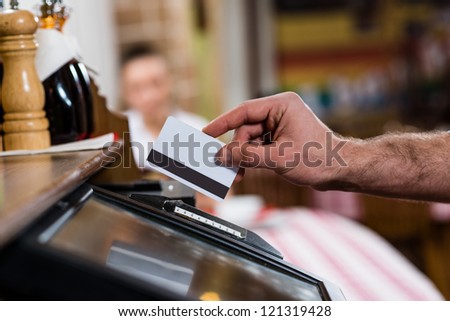 waiter inserts the card into a computer terminal, against visiting the restaurant