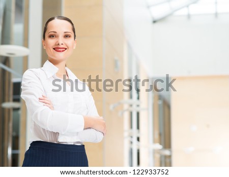 beautiful business woman standing in office with his arms crossed