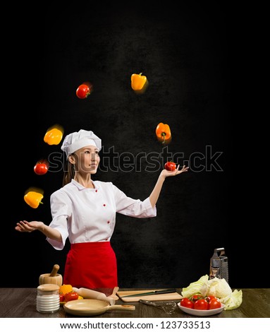 Asian woman chef juggling with vegetables, cooking skills