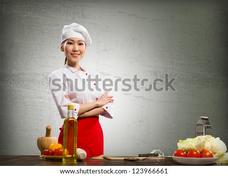 Asian cook woman crossed her arms and smiles