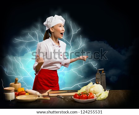 Asian woman furious chef shouting with clenched fists, lightning and flashes of light