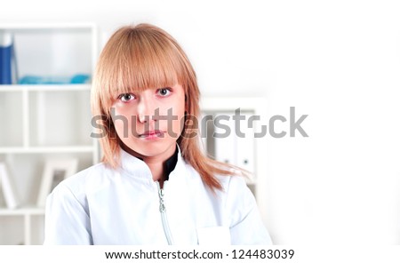 portrait of a beautiful woman doctor standing with folded arms