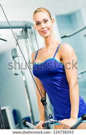 young woman doing body-building in the Gym, live a healthy life