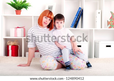 portrait of a pregnant woman and her son, at home