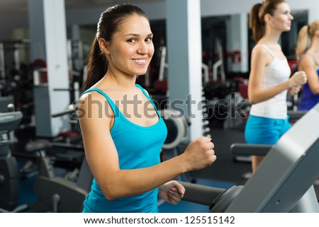 young women running on a treadmill, exercise at the fitness club