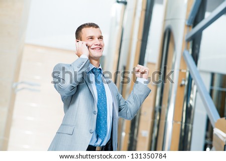 successful businessman talking on the phone and is happy to receive breaking news, to be successful in business