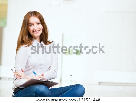 woman with tablet, sitting cross-legged on the floor