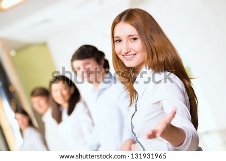 group of people holding hands, woman holds out her hand, the concept of teamwork