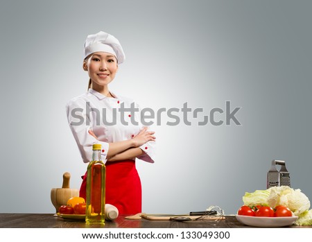 Asian cook woman crossed her arms and smiles