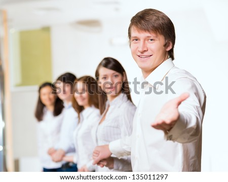 group of people holding hands, man holds out his hand, the concept of teamwork