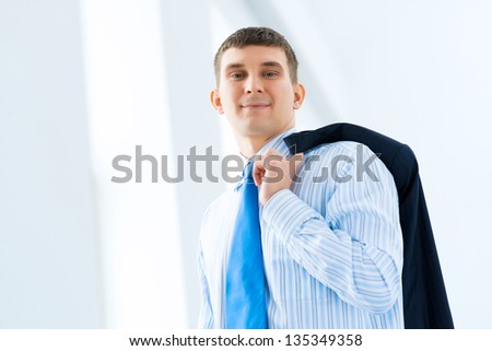 Portrait of a successful businessman, took off his jacket and hung it on his shoulder