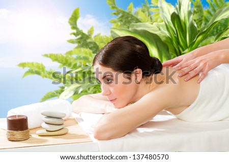 beautiful spa woman lying on a couch, female hands massaged