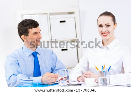colleagues discuss the reports at a desk in the office, working together in business