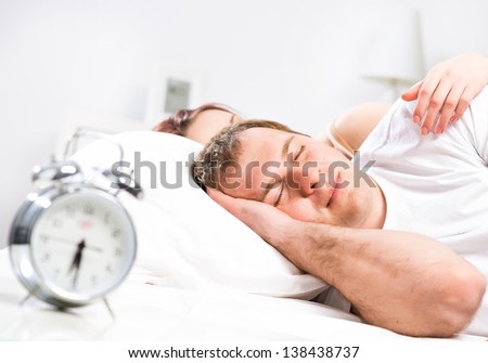 Mature man sleeping in bed with his wife