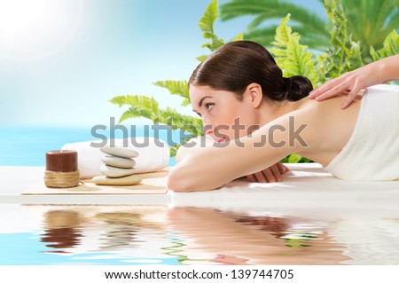 beautiful spa woman lying on a couch, female hands massaged
