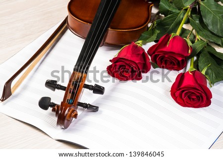 Violin, rose and music books, still life