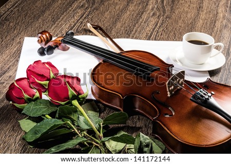 Violin, rose, cup of coffee and music books, still life