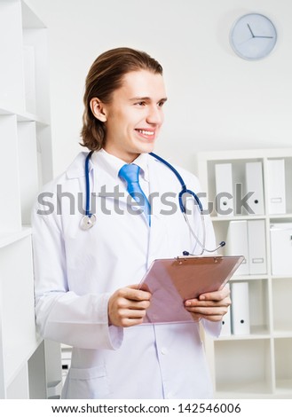 portrait of a doctor with a clipboard takes notes