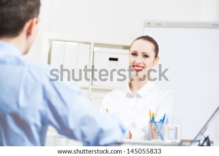 business woman holding an interview with a man in the office