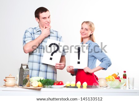 couple holding a plate with signs question and exclamation