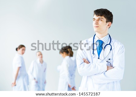Portrait of a successful young doctor and hospital staff