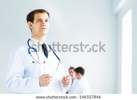 Portrait of a successful young doctor and hospital staff