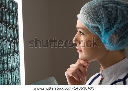 female doctor looking at the x-ray image attached to the glowing screen