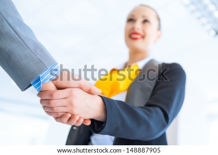young business woman shaking hands with a client, the agreement between the partners