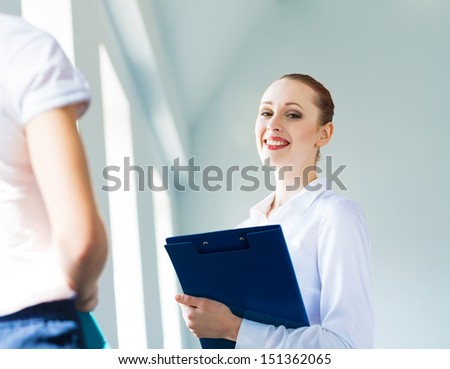 Young business woman talking with a colleague, interviews