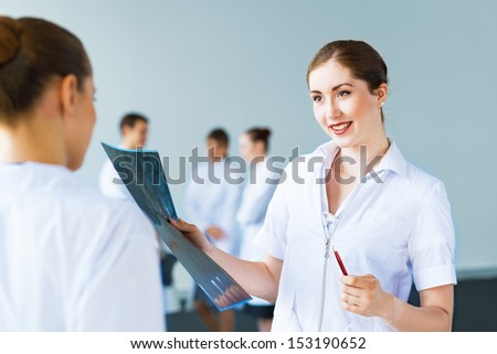 Doctor talking with a colleague, collaboration in medicine